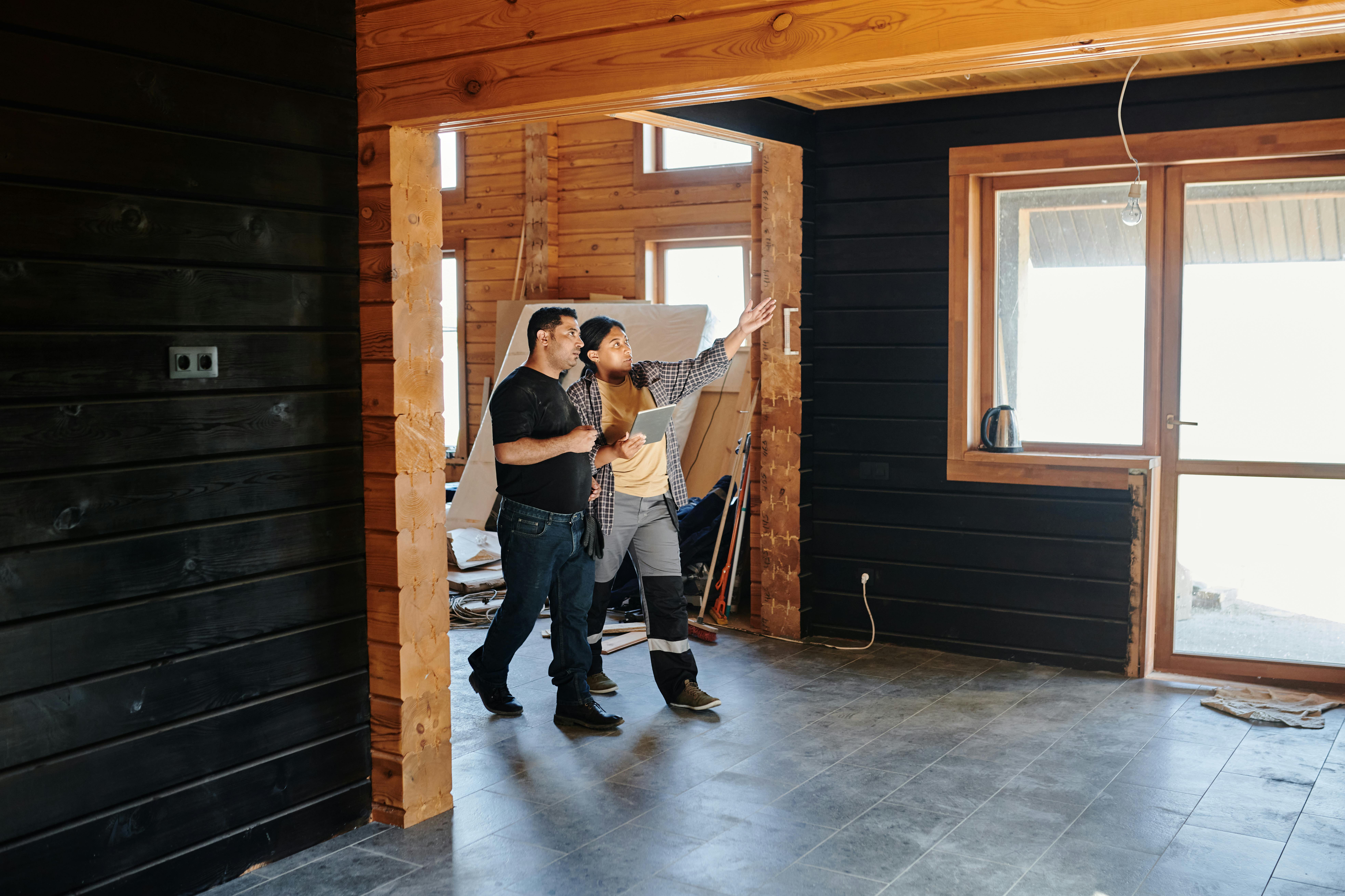 a contractor and client walking through a home being renovated